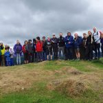 Walking group on top a hillside at Ghyll Head