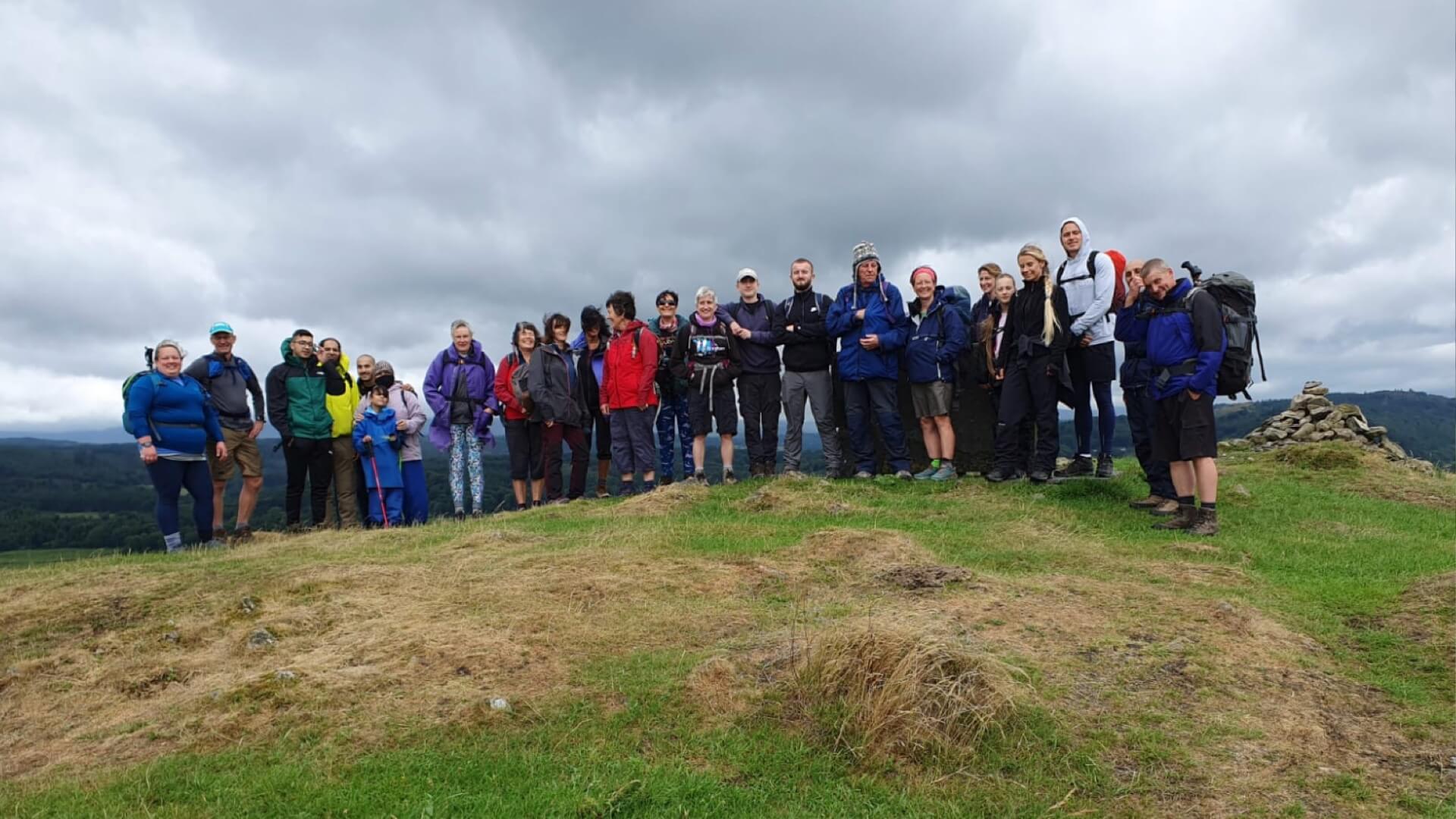 Walking group on top a hillside at Ghyll Head