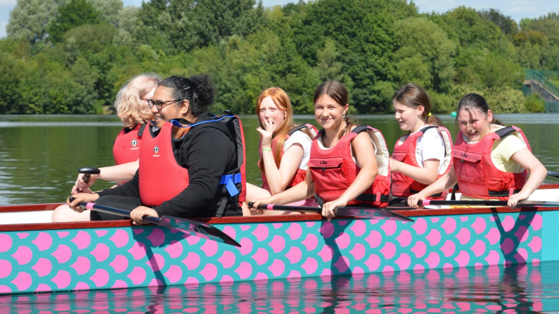 Members rowing on a lake